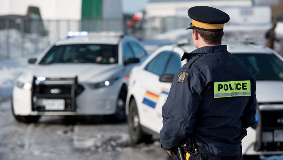 A policeman and police vehicles.