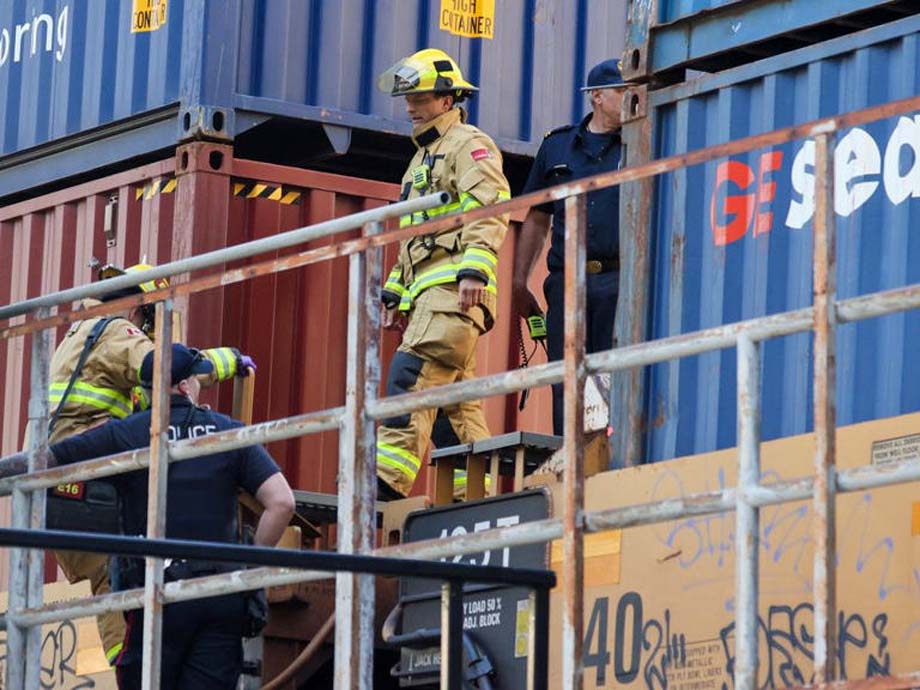 Calgary police and Calgary firefighters work at the scene.