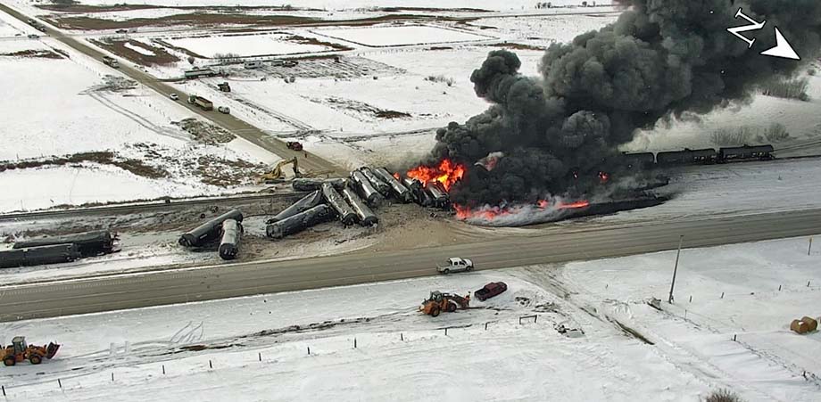 Breached tank cars burn some 7 hours after the derailment.