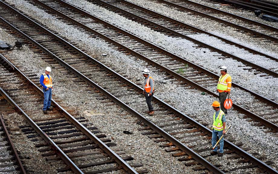 Rail workers on some tracks.