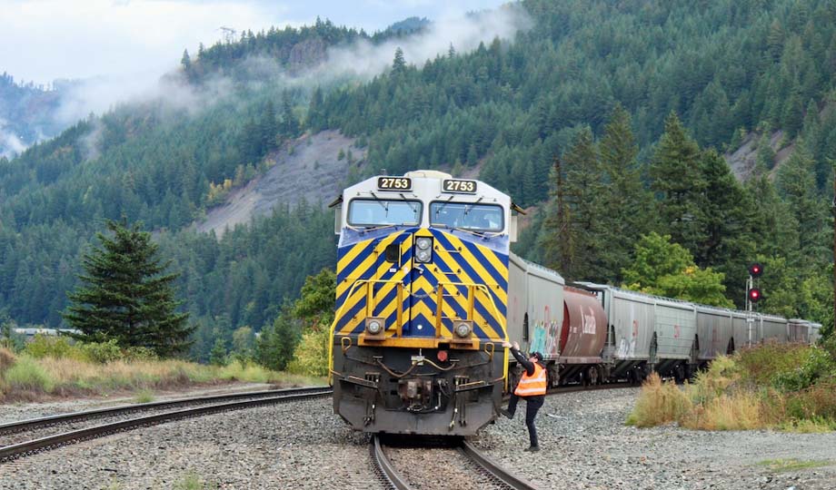 A crewman climbs aboard a CN train.