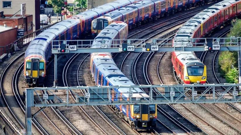 Four commuter trains on multiple tracks.