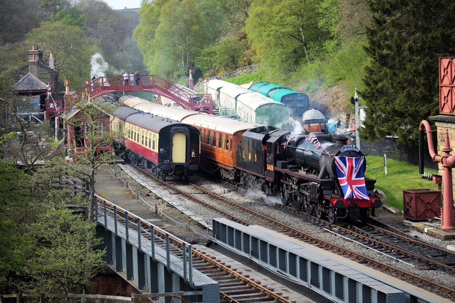 On coronation day a Black Five departs Goathland on the NYMR