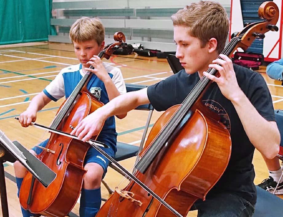 Nolan Branch mentors cellists Finn Miller left.