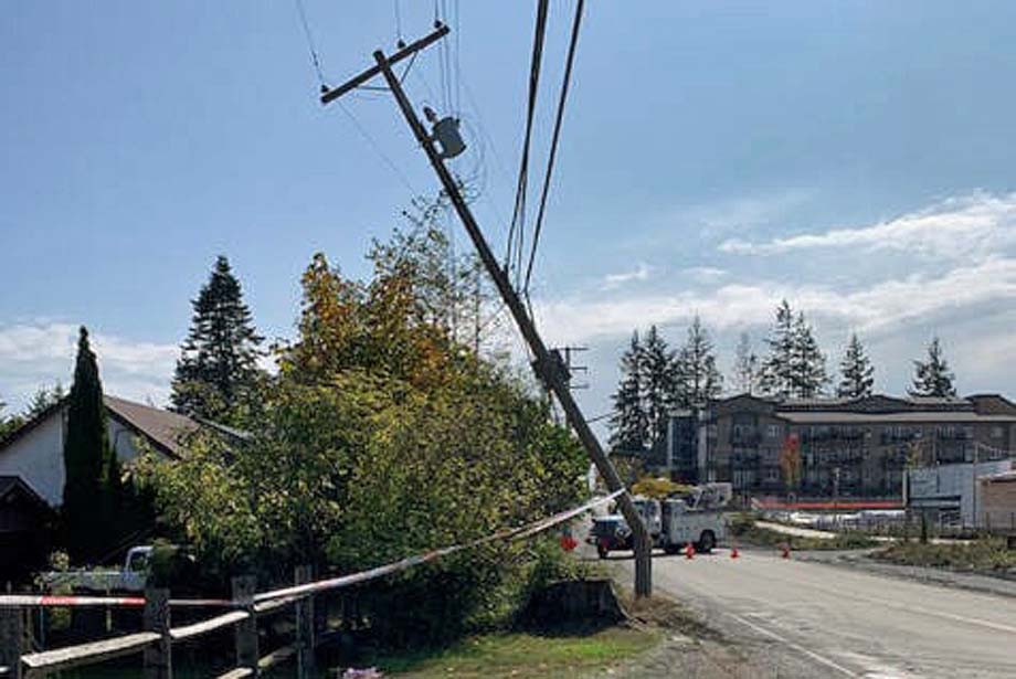 A broken power pole leans precariously.