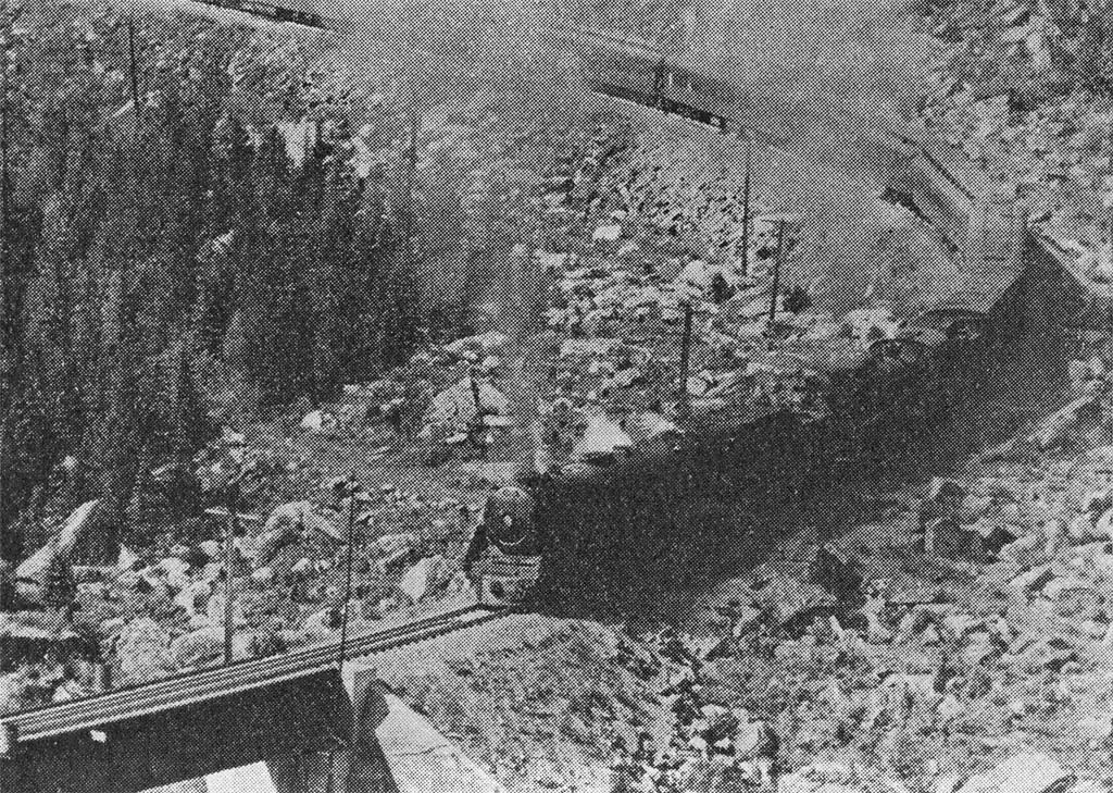 A passenger train crosses Kicking Horse River.