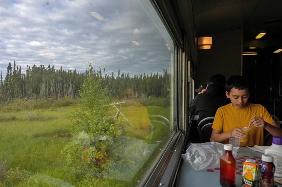 A passenger eats breakfast.