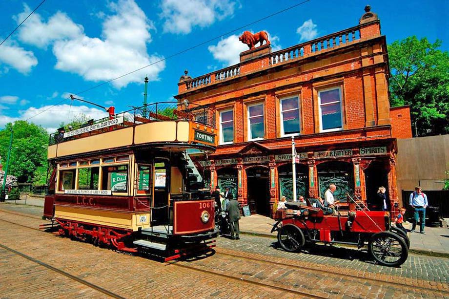 A tram and a classic car beside the Red Lion Pub.