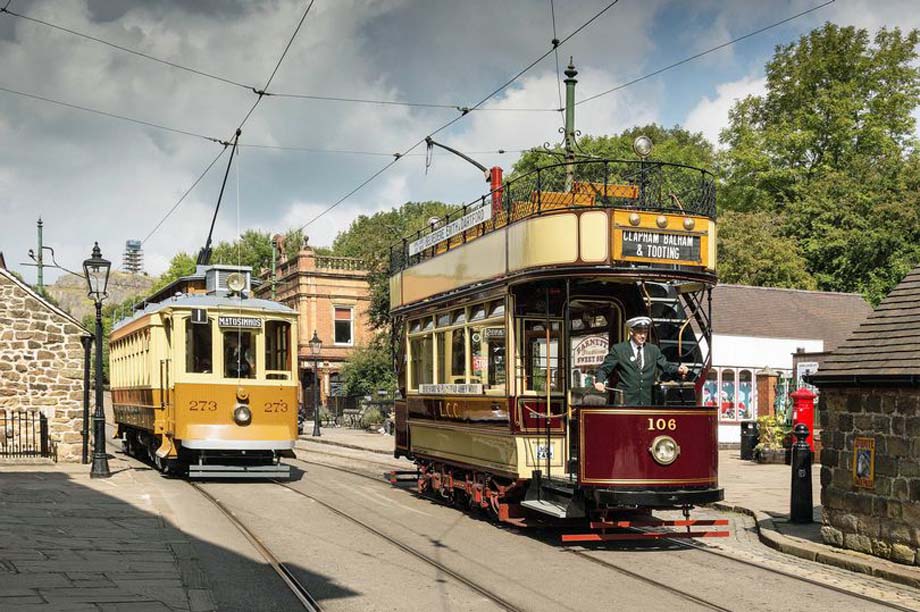 Two trams stopped on Crich Tramway Village's main street.