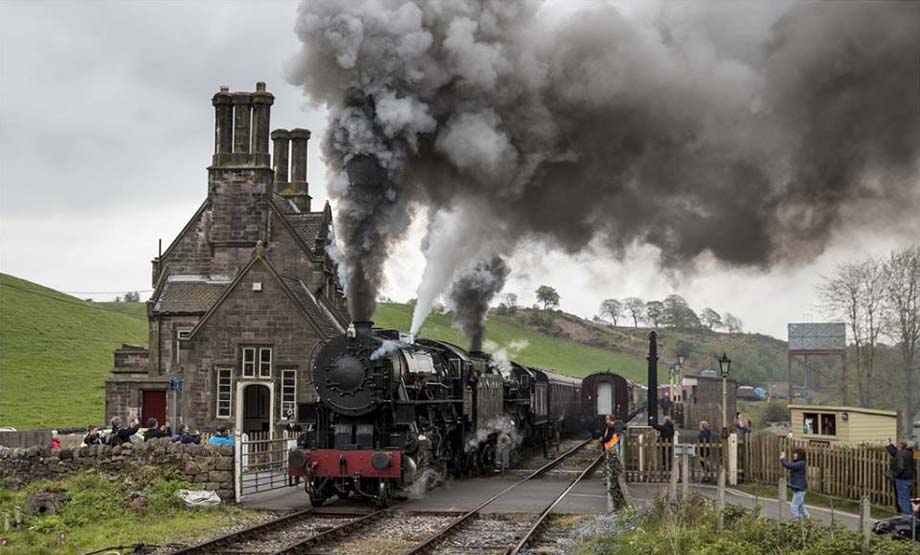 Double-headed USATC locomotives numbers 5197 and 6046 depart Cheddleton.