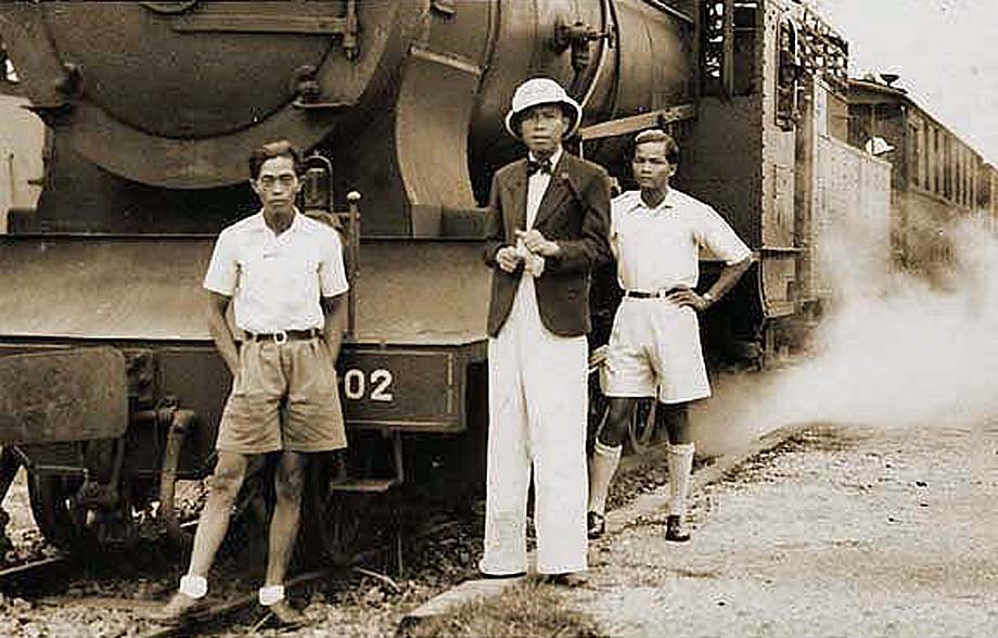 Chief of Di An station and his crew by a locomotive.